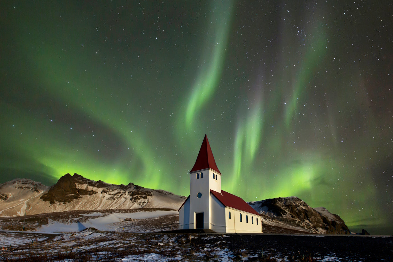 The northern lights over a church in a small village of southern Iceland. || AstroAnthony. (2017, November 24). The aurora or northern lights shot with a Canon camera over the Víkurkirkja church at Vik in Iceland on a clear night [Photograph]. Retrieved November 24, 2019, from Wikipedia: https://en.wikipedia.org/wiki/File:Church_of_light.jpg || https://creativecommons.org/licenses/by/4.0/